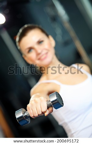 Image of fitness girl in gym exercising with dumbbells
