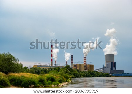 Panorama with a coal-fired power plant in Kozienice. Smoking stacks  and vapor from the cooling towers. Photo taken on a cloudy day with natural light. Royalty-Free Stock Photo #2006995919