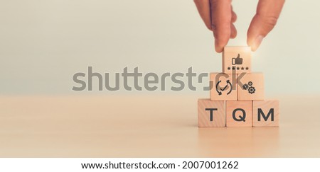 Total quality management (TQM) concept, Text and icon on wooden cubes with light background and copy space. A management approach to long-term success through customer satisfaction and sustainability. Royalty-Free Stock Photo #2007001262