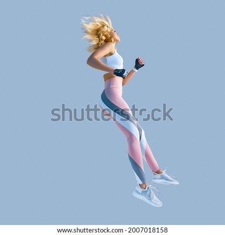 Profile picture of energetic inspired caucasian female in sportswear running and jumping, isolated along plain background. Motivation fitness concept photo