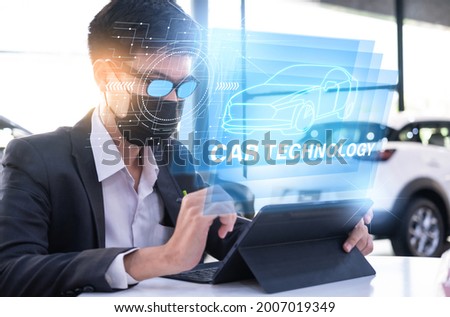 Asian man car inspection holding taplet application for service car for car futuristic vehicle graphical GUI interface intelligent. connected car. Internet display technician maintenance