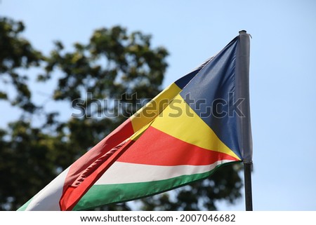 Waving Seychelles Flag. National Stripes On The Sky Background Close-Up