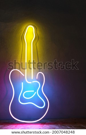 Pink, blue and yellow neon sign guitar. Trendy style. Neon sign. Custom neon. Music vibe.
