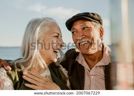 Cheerful senior couple enjoying a Ferris wheel by the Santa Monica pier Royalty-Free Stock Photo #2007067229