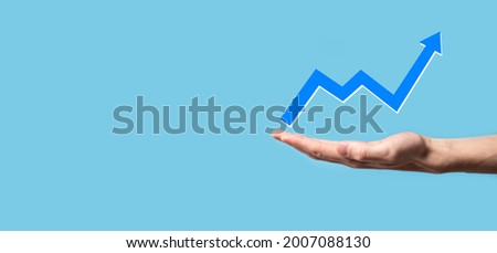 Hand hold drawing on screen growing graph, arrow of positive growth icon.pointing at creative business chart with upward arrows.Financial, business growth concept