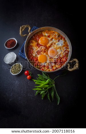 Famous Turkish menemen dinner on table, made by eggs, pepper and tomatoes. Royalty-Free Stock Photo #2007118016