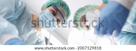 Group of doctors performing surgical operation in clinic
