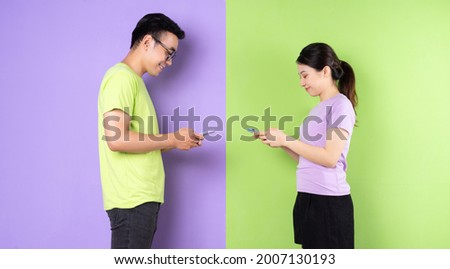 Young Asian couple using smartphone, long distance love concept
 Royalty-Free Stock Photo #2007130193