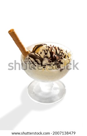 Ice cream with chocolate and wafer biscuit in glass cup isolated on white, copy space