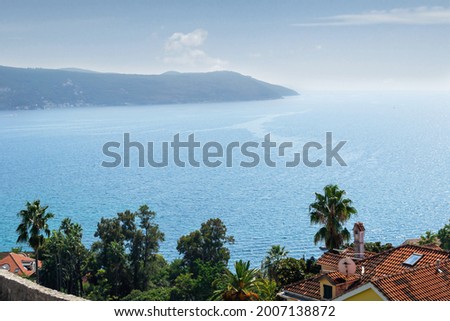 Seascape Southern Europe in sunny warm weather.beautiful view from the observation deck the Boka Kotorsky Bay The city is surrounded by mountains and rocks, at the foot of which the sea is overflowing