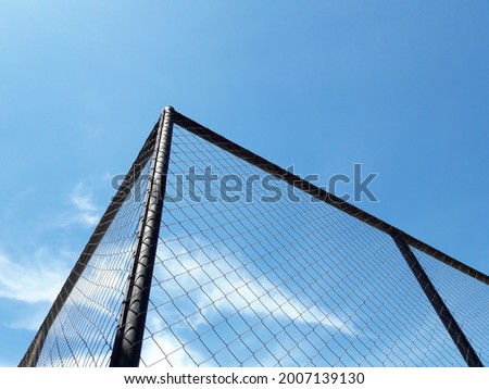 wire mesh photo with blue sky background