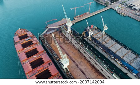 aerial view shipyard have crane machine and container ship in green sea . Royalty-Free Stock Photo #2007142004