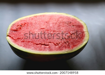 Half of watermelon on dark background. Selective focus.