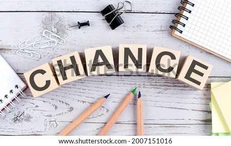 CHANCE text on wooden block with office tools on wooden background