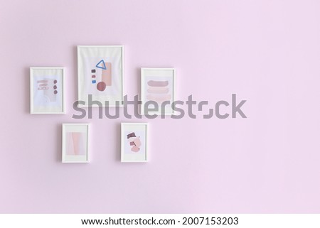 Beautiful pictures hanging on color wall