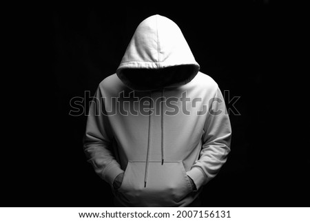 Man in white Hoodie. Boy in a hooded sweatshirt posing in dark