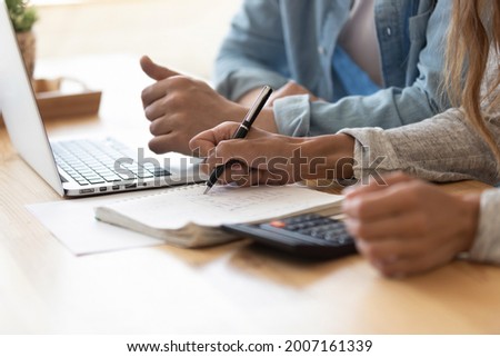 Close up spouses calculating family budget paying utility bills online using laptop, check loan payments, counting expenses. Economy, save money, finances management and planning, paperwork concept Royalty-Free Stock Photo #2007161339