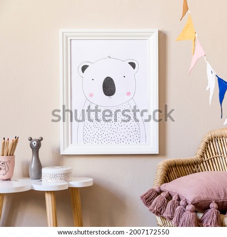 Stylish scandinavian nursery interior with mock up photo frame, plush toy, design furniture, toys and accessories. Beautiful decoration on the beige background wall. Home decor for children room.