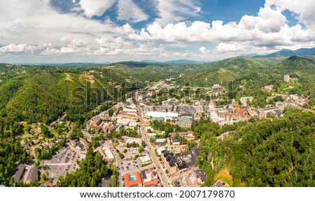 Aerial view of Gatlinburg above US-441. Gatlinburg is a popular mountain resort city in Sevier County, Tennessee, as it rests on the border of Great Smoky Mountains National Park. Royalty-Free Stock Photo #2007179870