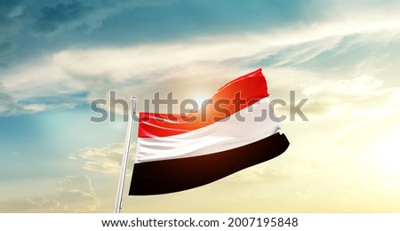 Yemen national flag waving in beautiful clouds. Royalty-Free Stock Photo #2007195848
