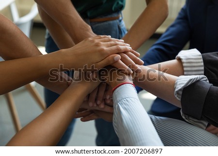 Business team stack of hands. Group of employees joining hands together, expressing respect, trust, support, keeping teambuilding, motivation, community spirit, celebrating success. Close up