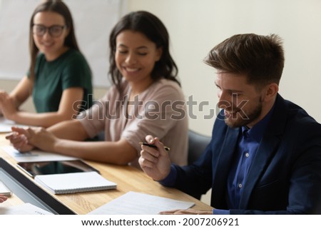 Happy confident businessman signing contract on meeting with partners, buying startup project, commercial property, closing deal, feeling legal documents, agreement, application, affixing signature Royalty-Free Stock Photo #2007206921