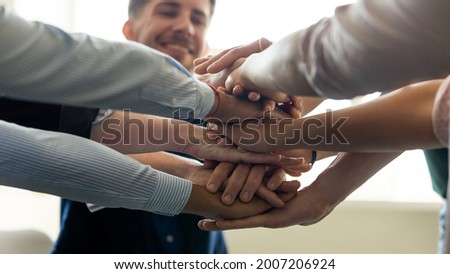Group stack of hands. Business team members, millennial office employees putting hands together, celebrating good teamwork result, success, work achieve, keeping friendship, community spirit, Close up