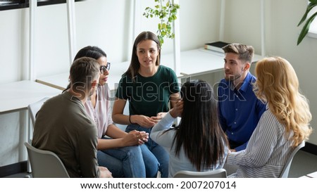 Diverse millennial team discussing mental health problems on group therapy meeting. Recovering addicts getting psychologist and community support, telling own addiction story on rehab session Royalty-Free Stock Photo #2007207014
