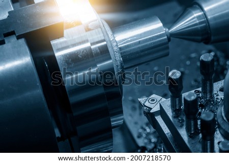 Close-up scene of chip insert of lathe cutting tool holding with the turret. The metalworking process by turning machine.
