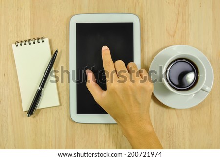 empty tablet computer and a cup of coffee on the desk
