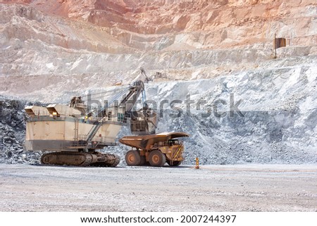 Electric rope shovel loading a dump truck at a copper mine in Peru Royalty-Free Stock Photo #2007244397