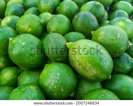 Pile of fresh green lemons, good for background and texture