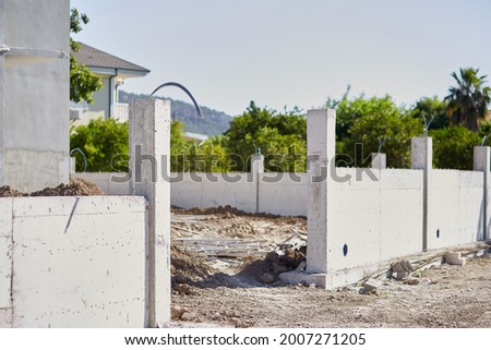 Home construction near the mountains on sunny day . High quality photo