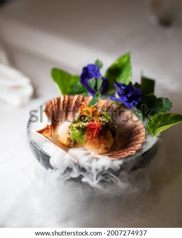 A picture of authentic Thai food which made of scallops. This is a Thai fusion food served in fine dining restaurant.