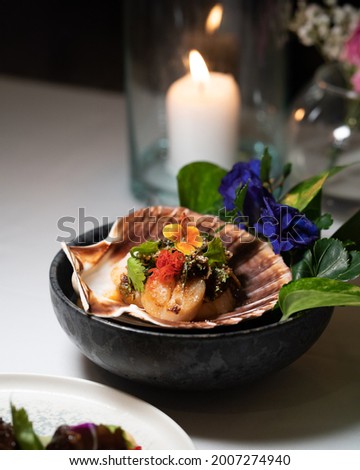 A picture of authentic Thai food which made of scallops. This is a Thai fusion food served in fine dining restaurant.