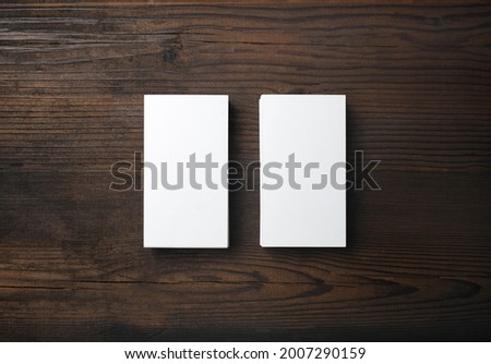 Photo of two blank business cards on wood table background. Branding ID template. Flat lay.