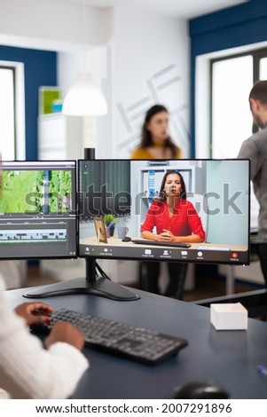 Black woman videographer in web online conference with project manager on video call editing client work, getting feedback on commercial movie using post production software on pc in start up office