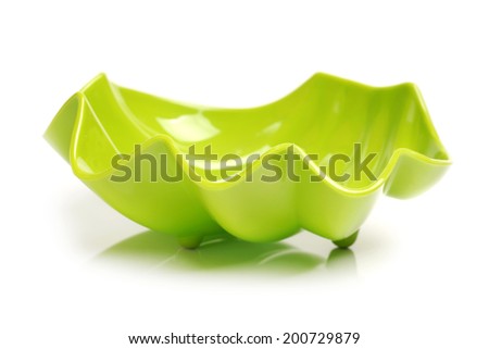 Bright green plastic empty bowl on a white background 