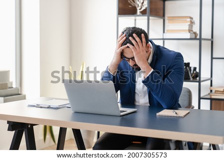 Huge serious problems, businessman is fired, negative results of audition, debt and loan concept.Making mistake, solving difficult troubles with business.Unhappy tired stressed workaholic at workplace Royalty-Free Stock Photo #2007305573