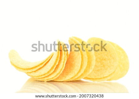 Delicious light yellow potato chips, close-up, isolated on white. Royalty-Free Stock Photo #2007320438