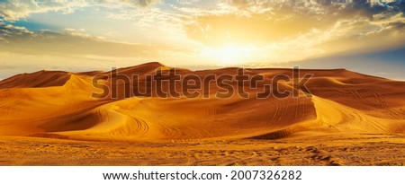 Golden Sand Dune Desert Landscape Panorama. Beautiful sunset over the sand dunes in the Al Madam Desert, Sharjah, UAE.