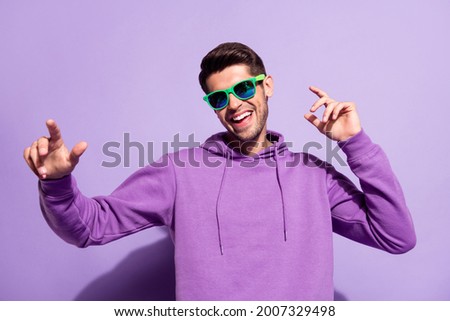 Photo portrait man smiling in sunglass dancing at party isolated pastel violet color background