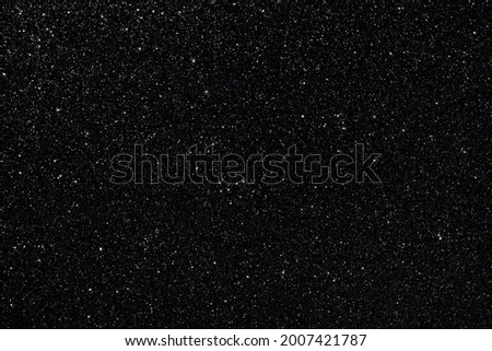 Black glitter texture sparkling festive glowing shiny wrapping paper background for Christmas and New Year party, copy-space holiday wallpaper decoration, greeting and Black Friday invitation card.