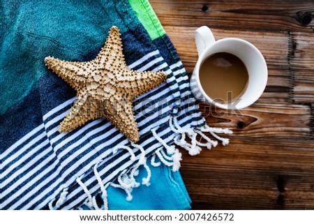 Closeup Photo of a Beautiful Still Life in Beach House. Morning Coffee and Starfish. Relaxing Summer Vacation Concept.