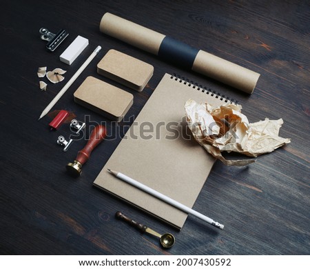Photo of blank kraft stationery set on wooden background. Corporate identity mock up for placing your design.