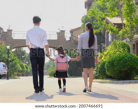 Young parents send their children to school high quality photo