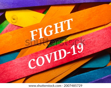 Medical concept.Text FIGHT COVID-19 on colorful wooden stick background.