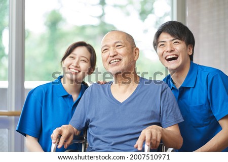 Asian Laughing Elderly and Caregivers