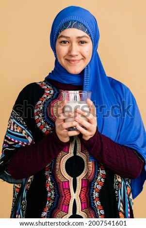 Muslim woman with a glass of soy milk Royalty-Free Stock Photo #2007541601