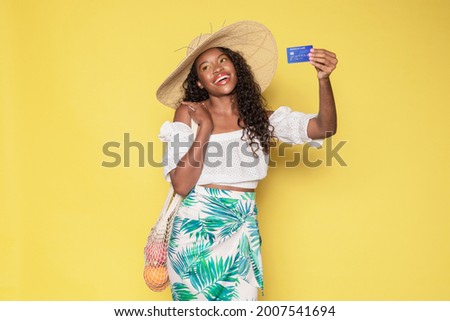 Tanned woman enjoying her summer vacation using a credit card